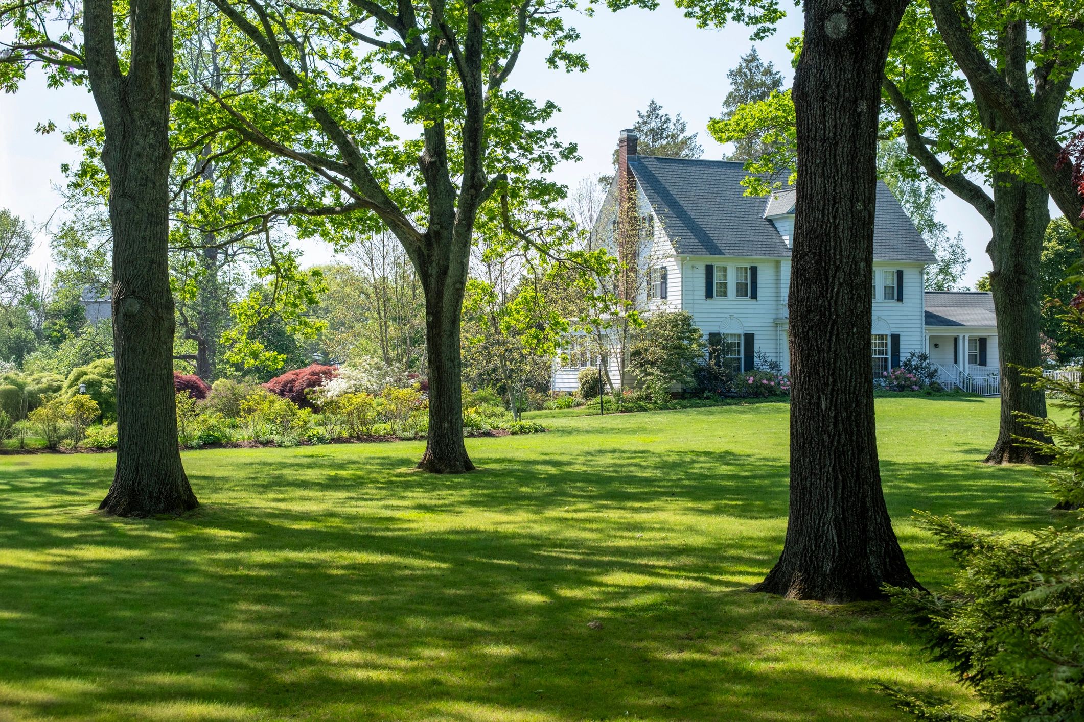 Classic white country house with a green lawn