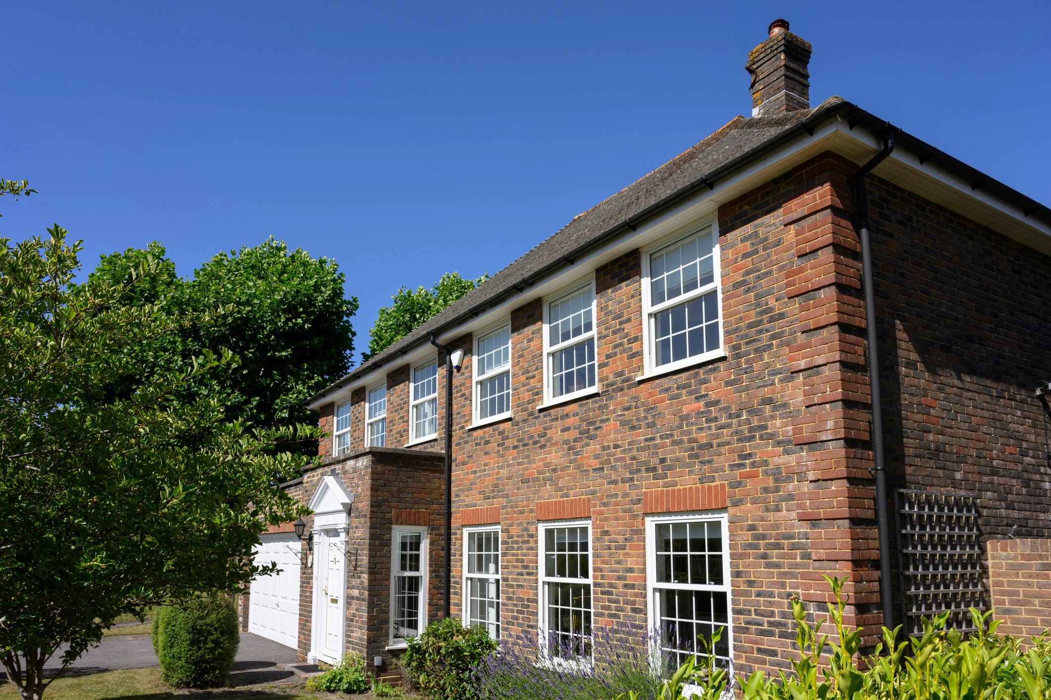 Traditional brick house with white windows